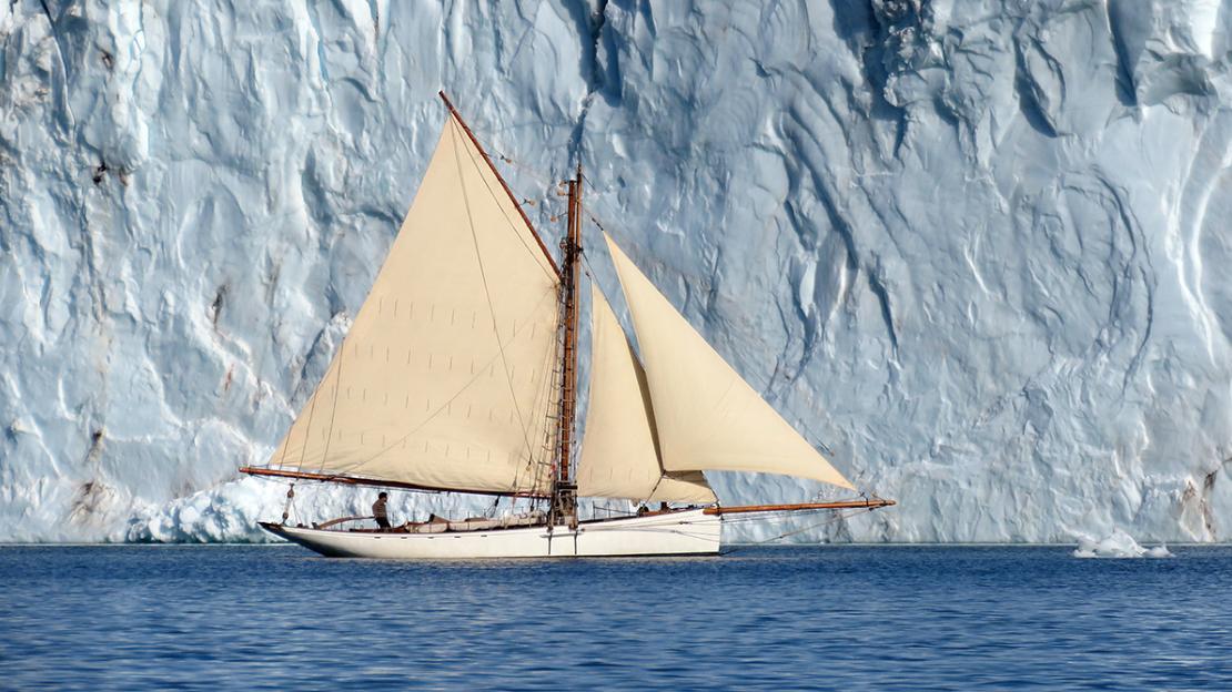 INTEGRITY sailing along a wall of ice.